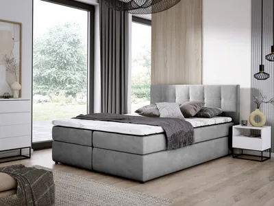 A bedroom scene with a bed, dresser, and nightstand.