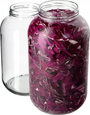 Two glass jars, one empty and one filled with chopped red cabbage.
