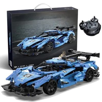 A blue remote-controlled sports car building set, shown with its packaging and remote control.