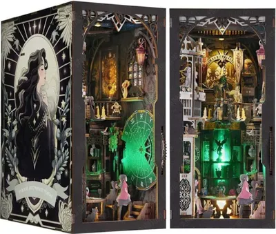 A diorama-style book nook kit with intricate details and LED lighting, presented in a box with artwork.