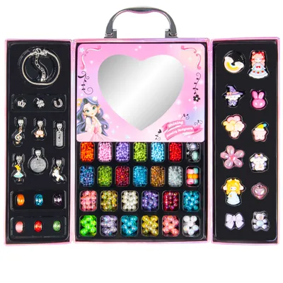 A pink jewelry-making kit for children, open to reveal compartments filled with beads, charms, and a mirror.