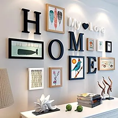 A wall decorated with letters and framed pictures, forming the word 'HOME' and 'My Love'.