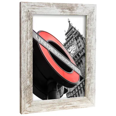 A framed picture of a London Underground sign with Big Ben in the background.
