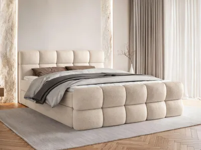 A bed with bedding in a room.