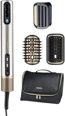 A hair dryer and its attachments are laid out on a white background.
