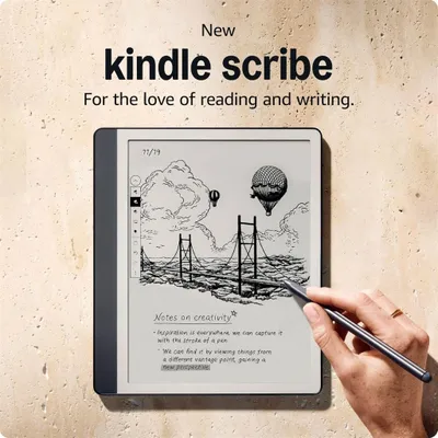 A hand is shown writing on a Kindle Scribe device, which displays a drawing and text. The background is a textured wall.