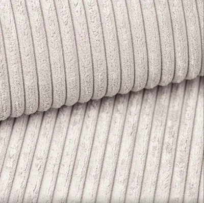 A close-up, overhead view of beige corduroy fabric.