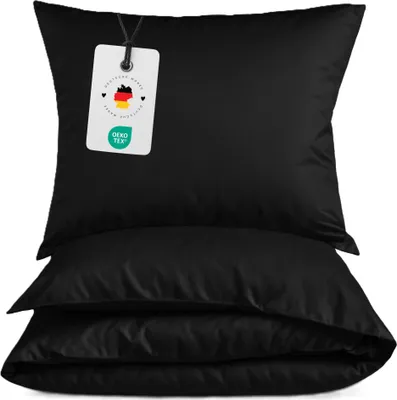 A stack of black pillowcases with a product tag attached to the top one.