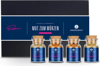 A gift box containing four small spice jars.
