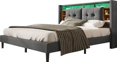 A modern upholstered bed frame with a headboard featuring integrated shelving and LED lighting.