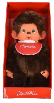 A Monchhichi doll is presented in its red packaging.