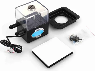 A computer water cooling pump and reservoir unit with accessories, laid out on a white background.