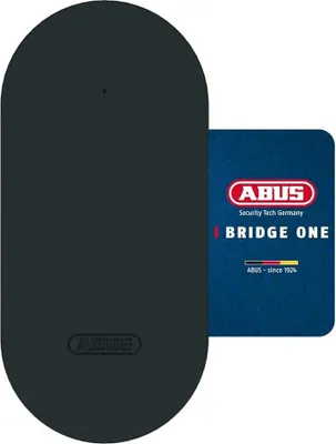 A black ABUS WLAN bridge device with a blue card displaying the ABUS logo and product name.