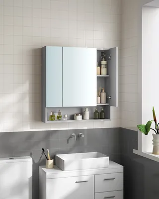 A bathroom cabinet with mirrors and shelves, above a sink and vanity.