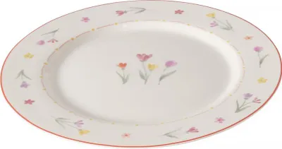 A white oval plate with a delicate floral pattern around the rim and in the center.