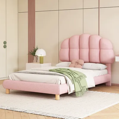 A pink upholstered bed in a bedroom setting.