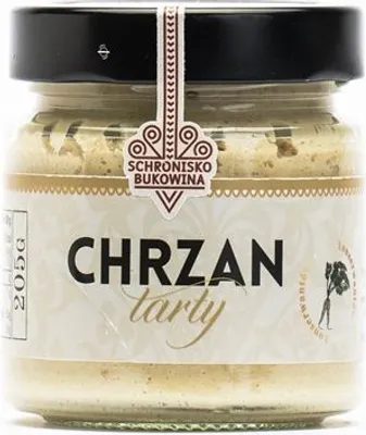 A jar of grated horseradish on a white background.