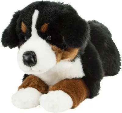 A plush toy dog lying down.