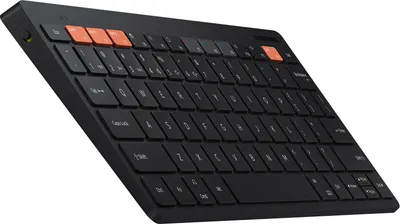 A black Samsung Smart Keyboard Trio 500 with orange accent keys is shown from a slightly elevated side angle against a white background.