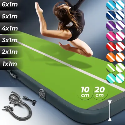 A gymnast is jumping on a green air track mat. The mat has a white line down the center. There are also color swatches and size indicators on the mat.