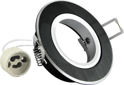 A close-up studio shot of a black recessed ceiling light fixture with a brushed metal finish and a white inner ring, shown with a separate light socket connector.
