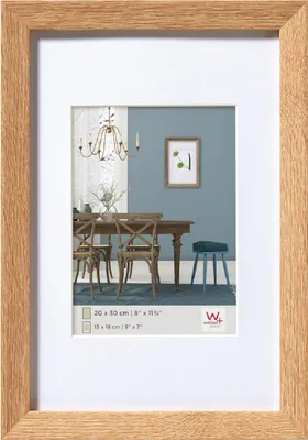 A framed picture of a dining room scene.