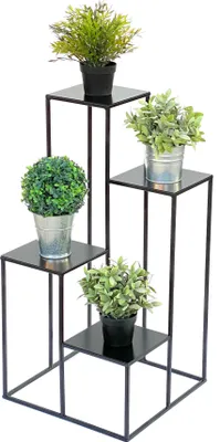 A black metal plant stand with four tiers, holding four artificial plants in pots.