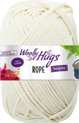 A ball of cream-colored yarn with a label wrapped around it.