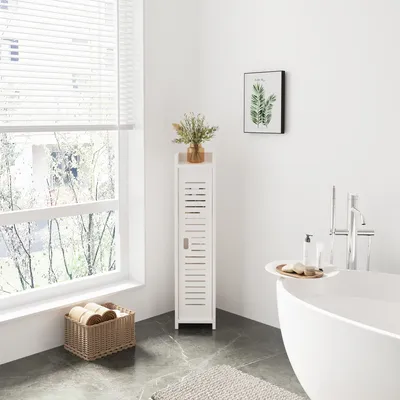 A bathroom scene with a white cabinet, bathtub, and window.