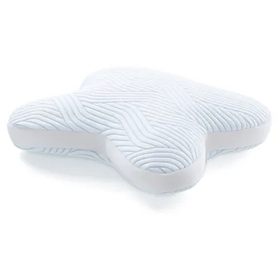 A light blue and white pillow with a wave-like pattern.