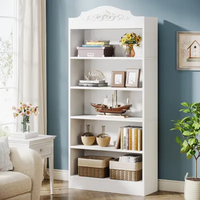 A white bookshelf filled with books and decorative items in a room with a blue wall and a window with curtains.