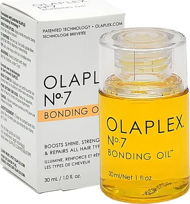 A bottle of Olaplex No. 7 Bonding Oil and its packaging are shown against a white background.