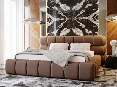 A luxurious bedroom with a large upholstered bed as the focal point.
