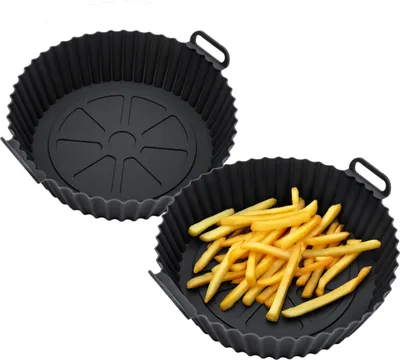 Two black silicone air fryer baskets, one empty and one filled with french fries, are shown against a white background.