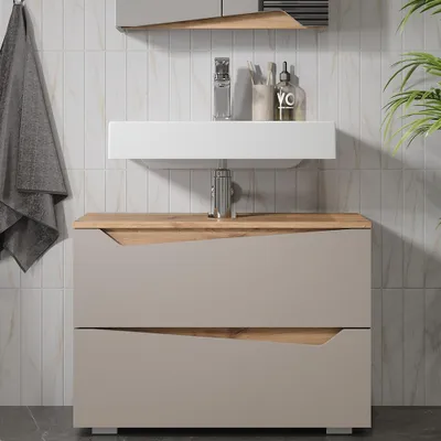 A modern bathroom vanity with a sink and cabinet.