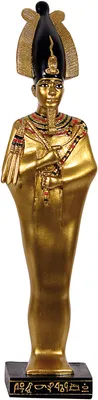 A golden statue of an Egyptian god, likely Osiris, on a black base with hieroglyphs.