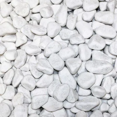 A close-up, overhead view of a pile of white marble pebbles.