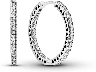 A pair of silver hoop earrings with heart cutouts and small clear stones, displayed against a white background.