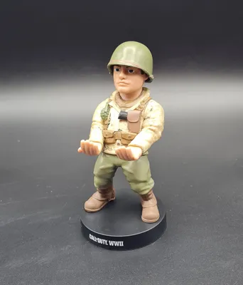 A figurine of a soldier from Call of Duty: WWII stands on a black base.