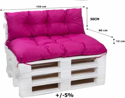 A pink cushion set on a white wooden pallet sofa.