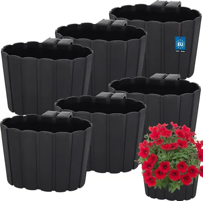 A set of black hanging planters with red flowers in one of them, arranged on a white background.