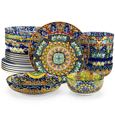 A set of colorful, patterned ceramic dishes and bowls are arranged on a white background.
