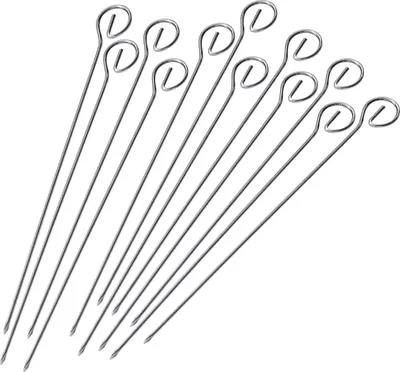 A collection of stainless steel skewers arranged diagonally on a white background.