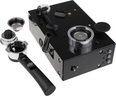 A black espresso machine part with accessories.