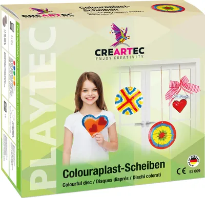 A product box for a craft kit, featuring a young girl holding a heart-shaped craft and examples of finished crafts hanging on a door.