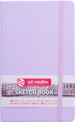 A closed sketchbook with an elastic band and a label band around it.