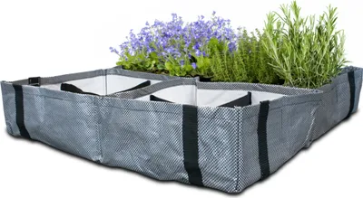 A fabric planting bag with multiple compartments filled with plants.