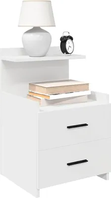 A white nightstand with two drawers, a shelf, a lamp, an alarm clock, and books.