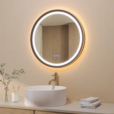 A modern bathroom vanity with a round LED mirror above a vessel sink.