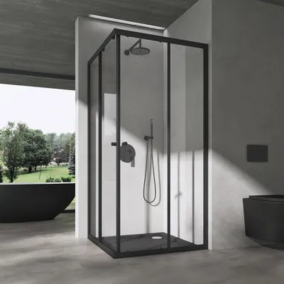 A modern bathroom with a black shower cabin, a black bathtub, and a black toilet.